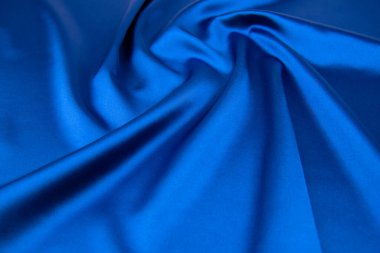 Arkaplan olarak mavi saten veya ipek kumaş