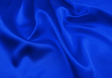 Arkaplan olarak mavi saten veya ipek kumaş