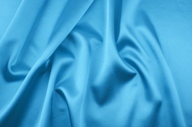 Arkaplan olarak mavi saten veya ipek kumaş