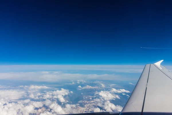 Vista aérea de nuvens brancas, céu azul e asa da aeronave — Fotografia de Stock