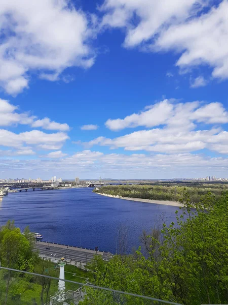 View of the city and the river from above. City landscape. Green park and nature. Panorama.