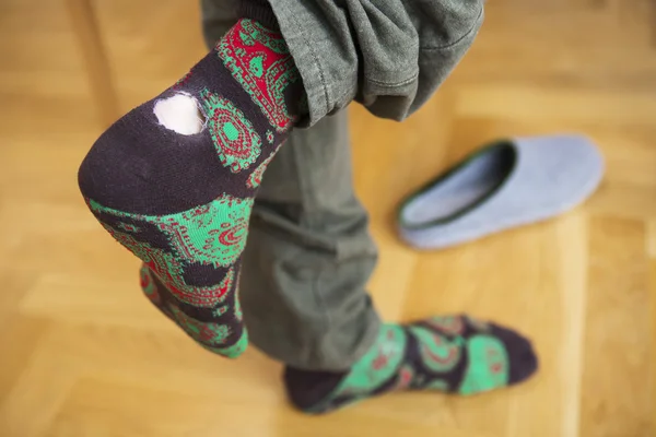 Primer plano de los pies del hombre con calcetines con agujero — Foto de Stock