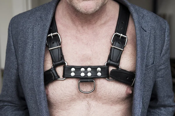 Close-up of man's chest wearing leather harness and jacket — Stock Photo, Image