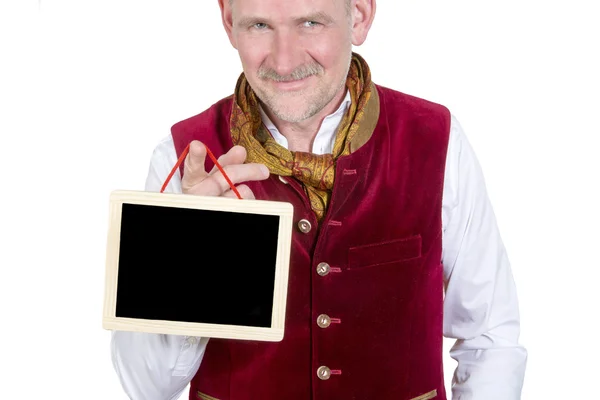 Retrato do homem bávaro segurando um pequeno quadro negro — Fotografia de Stock