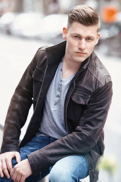 Young blond man sitting outside — Stock Photo, Image