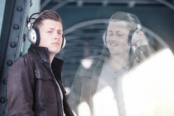 Double exposure of young man with headphones — Stock Photo, Image