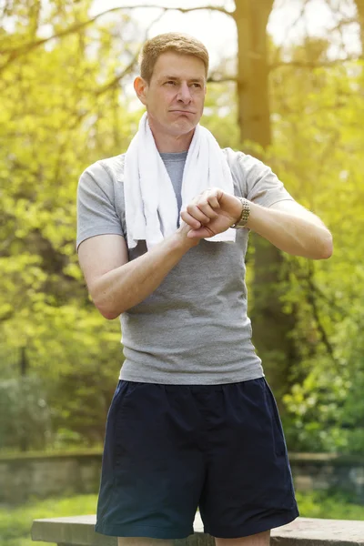 Man outdoors looking at his watch — Stock Photo, Image