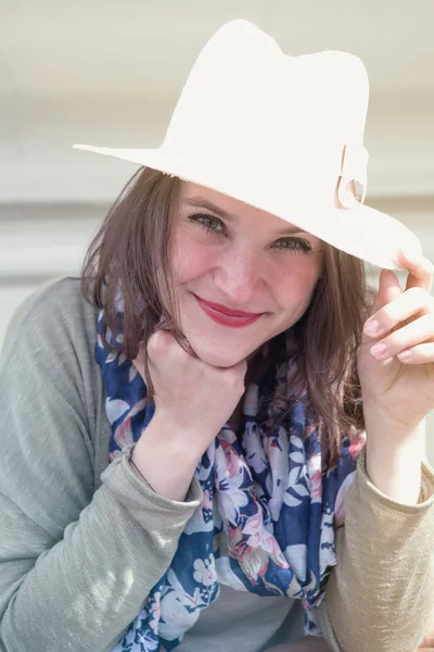Πορτραίτο νεαρής γυναίκας που φοράει ένα καπέλο και χαμογελαστός — Φωτογραφία Αρχείου