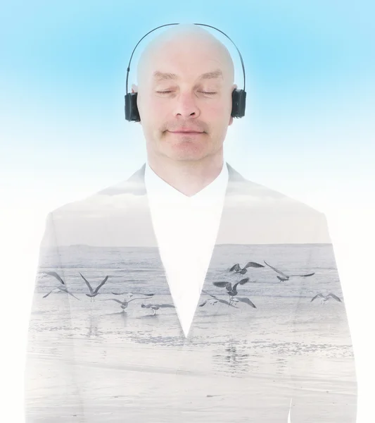 Double exposure of man with headphones and beach — Stock Photo, Image