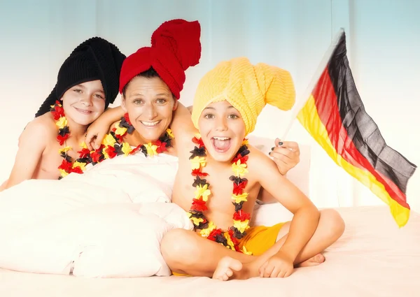 Mother and two sons cheering with german flag — Stock Photo, Image