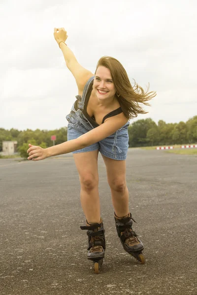 Νεαρή γυναίκα είναι rollerblading στο δρόμο — Φωτογραφία Αρχείου