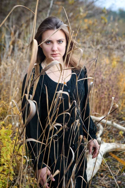 Brunette Woman Black Dress Standing Reed Looking Sad — Stock Photo, Image