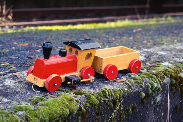 wooden toy train  with big train in the background