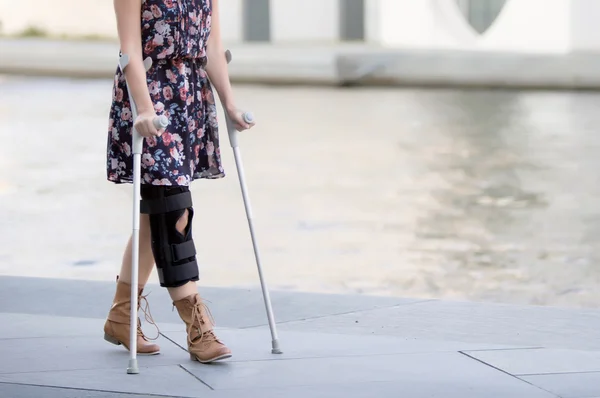 Close up of woman with crutches — Stock Photo, Image