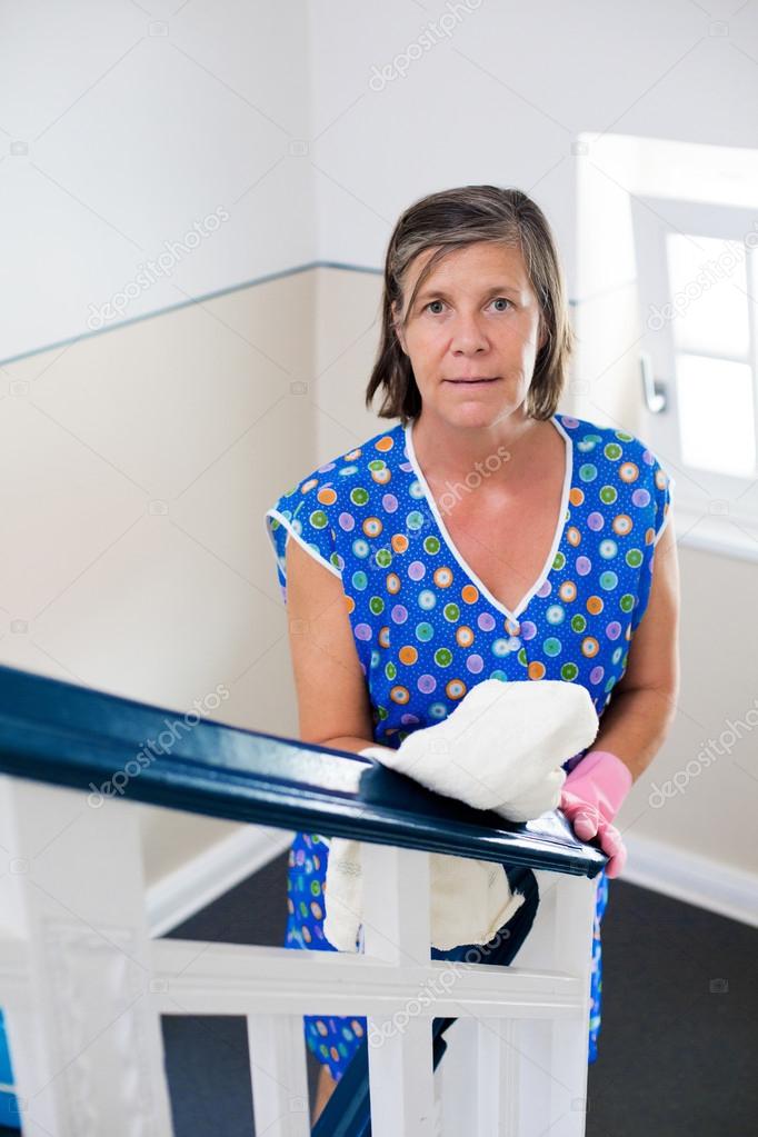 woman cleaning banisters