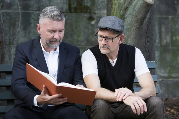 Two men with a book — Stock Photo, Image