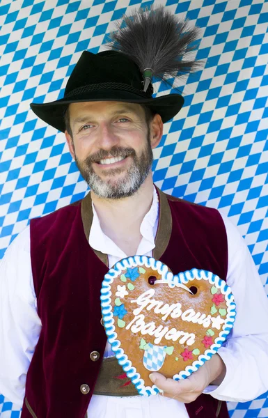 Bavarian man with gingerbread heart — Stock Photo, Image