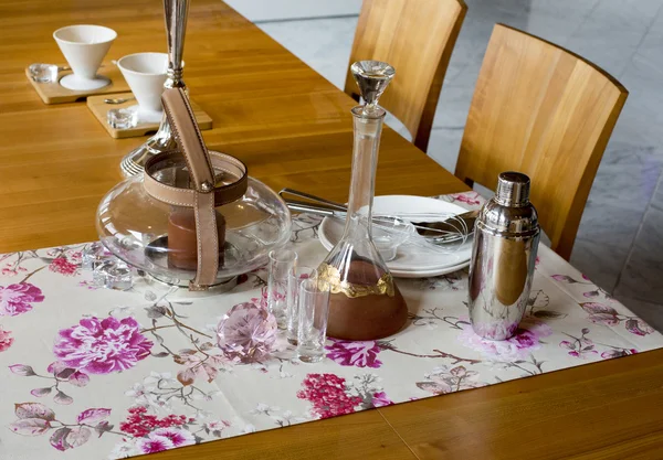 Table with glas teapot and plates — Stock Photo, Image