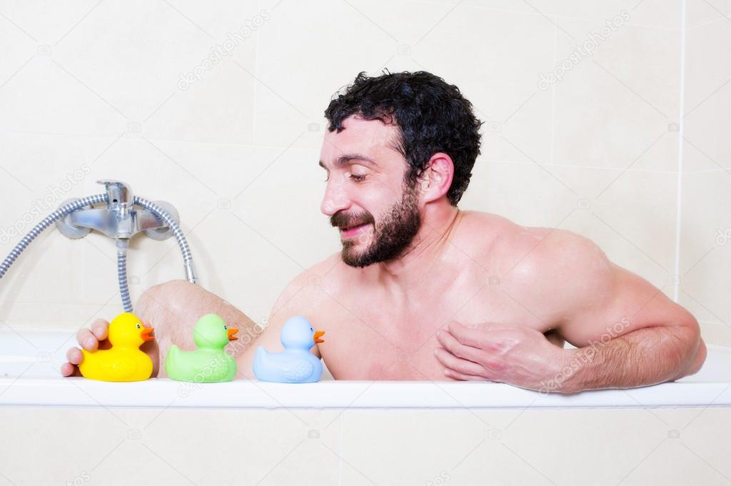 Man in bathtub with rubber duck
