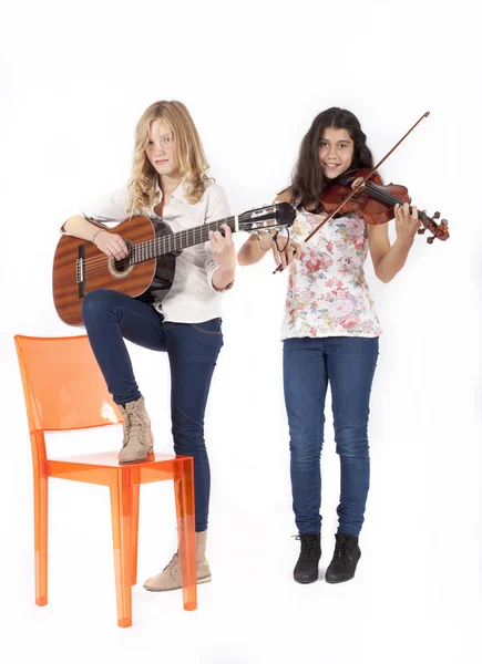 Two girls playing musical instruments — Stok Foto