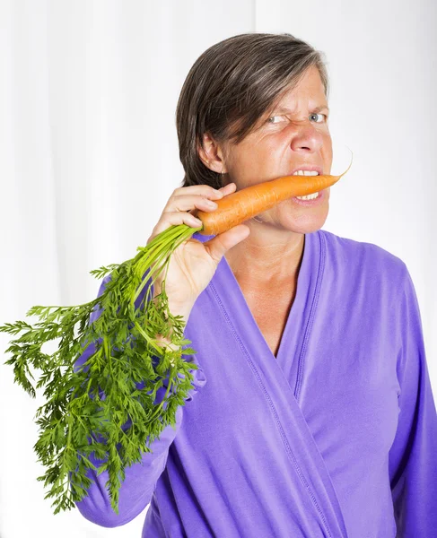 Woman with carrot — Stock Photo, Image