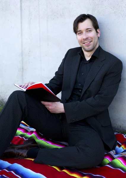 Hombre de negocios está leyendo un libro al aire libre — Foto de Stock