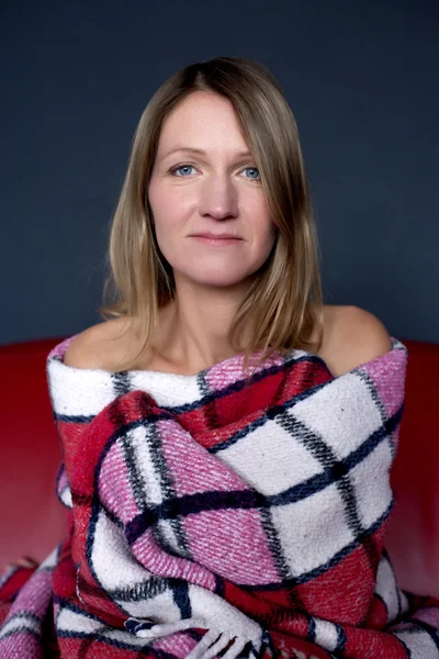 Portrait of a blond woman covered in a blanket — Stock Photo, Image