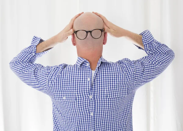 back of a bald head with glasses