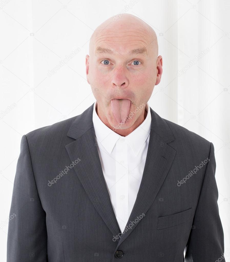 man sticks out his tongue