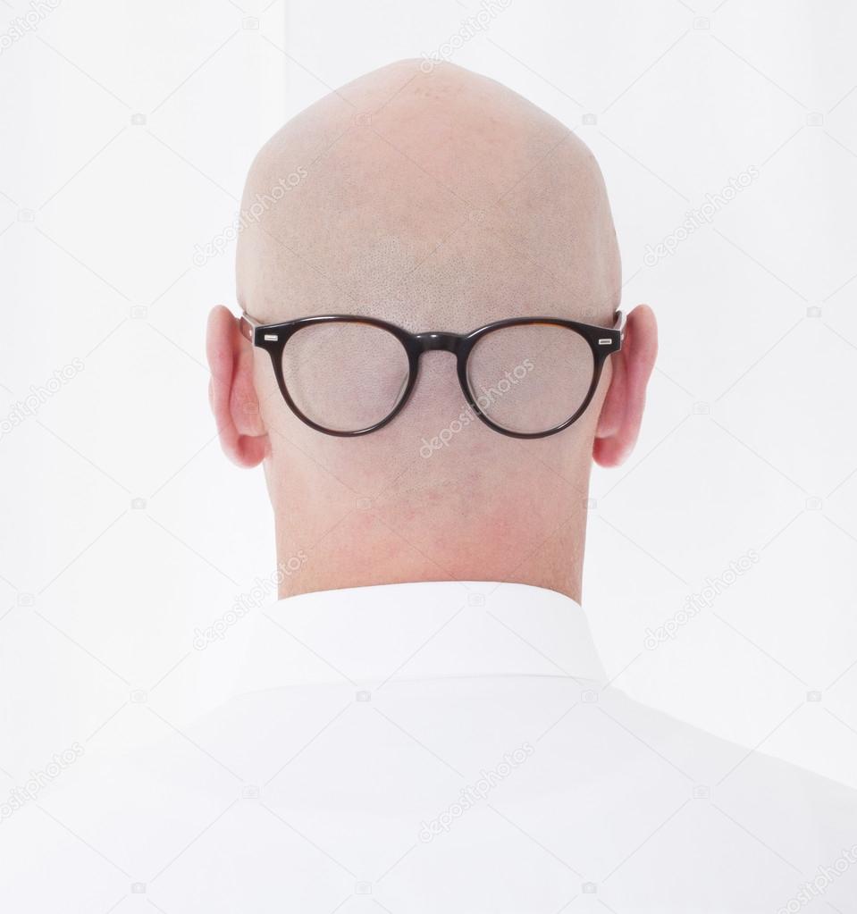 back of a bald head with glasses