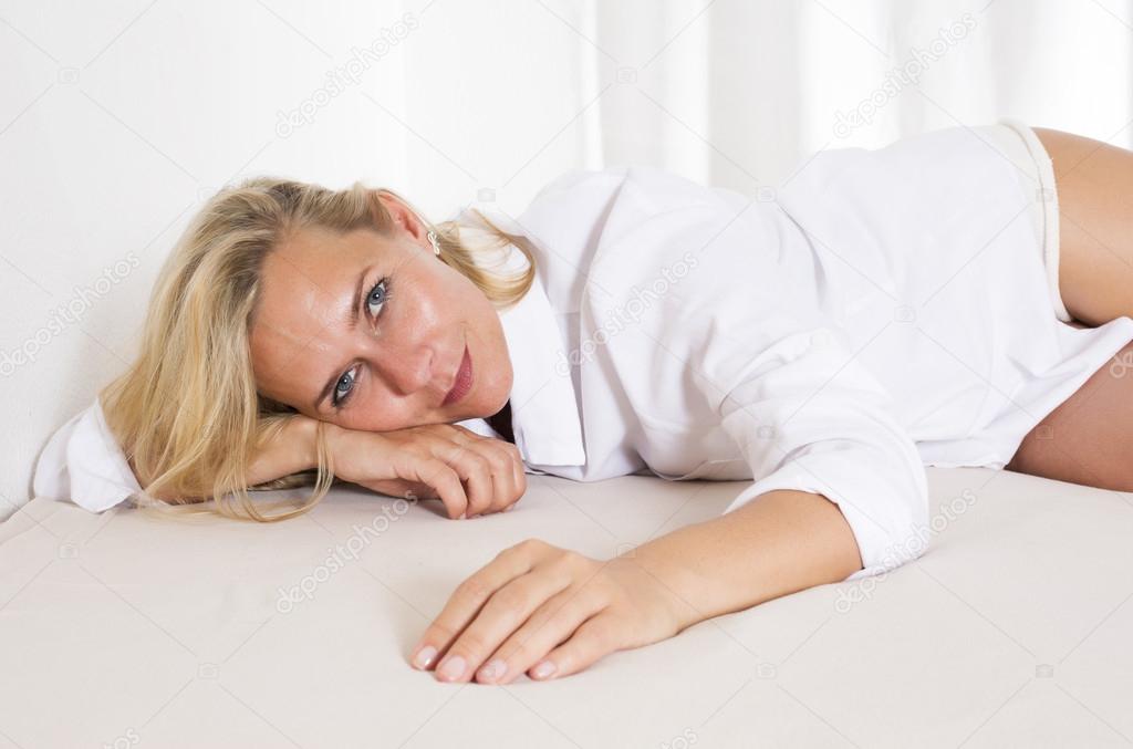 portrait of a blond woman in bed