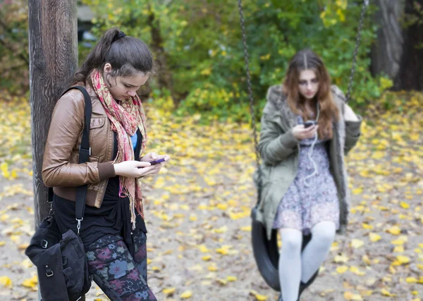 Två tjejer med telefoner — Stockfoto