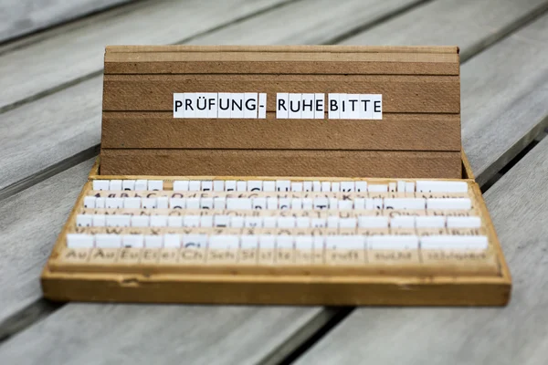 German text: "Pruefung-Ruhe Bitte" — Stock Photo, Image