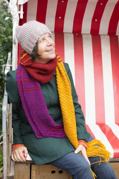 Woman sitting outside in a chair — Stock Photo, Image