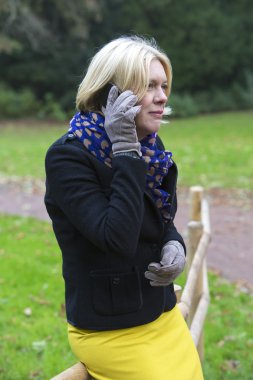 kadın parkta bir telefon ile