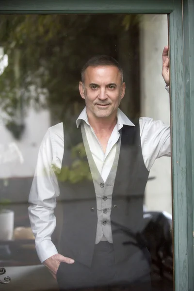 Man looking out of a window — Stock Photo, Image