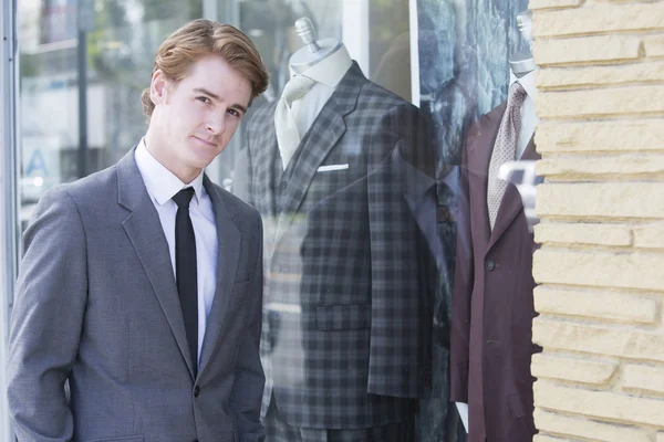 Man in suit at a storefront — Stock Photo, Image