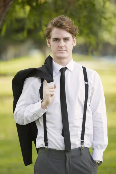 Man in suit standing in park — Stock Photo, Image
