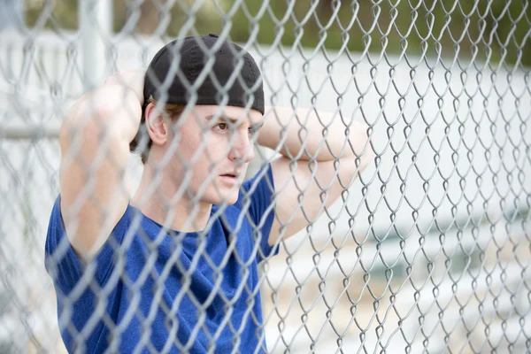 Молодой человек за забором — стоковое фото