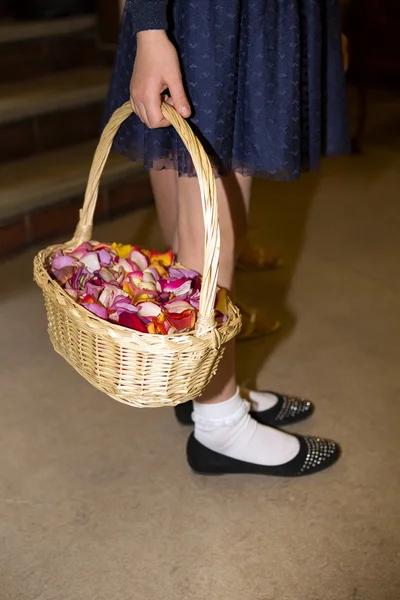 Close-up of a flowergirl holding a basket — Stock Photo, Image