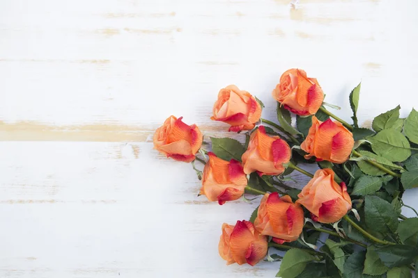 Оранжевые розы на белом деревенском деревянном фоне — стоковое фото