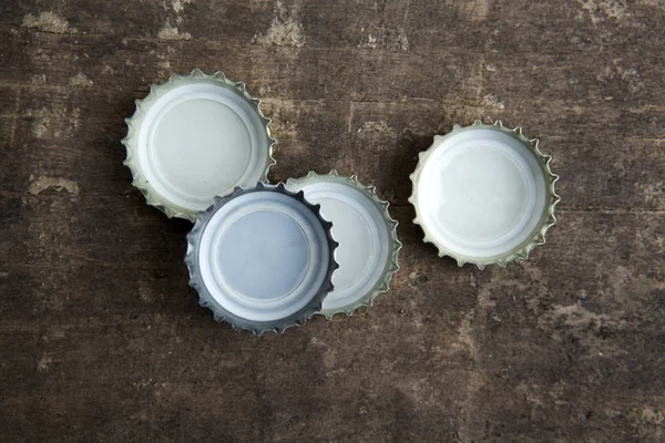 bottle caps on rustic wooden background