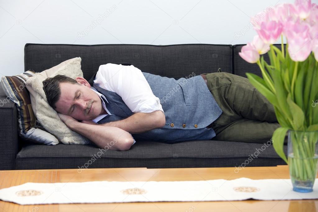 man sleeping on couch