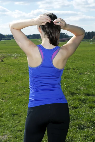 Backside of woman with ponytail outdoors — Stock Photo, Image