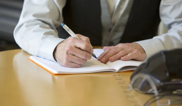 Close-up of man's hands signing a paper Royalty Free Stock Photos