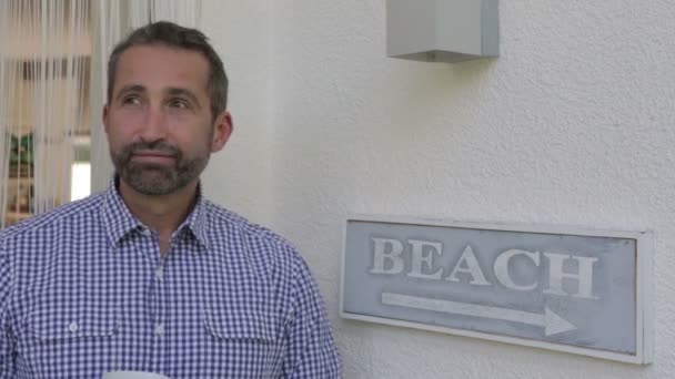 Man walking on his patio with a cup of coffee — Stock Video