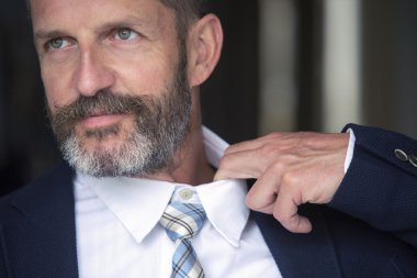 closeup of man loosens his shirt