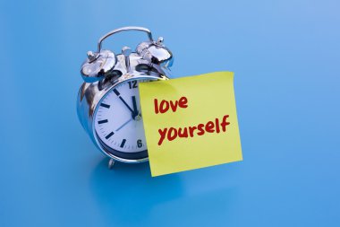alarm clock with text: 'love yourself'