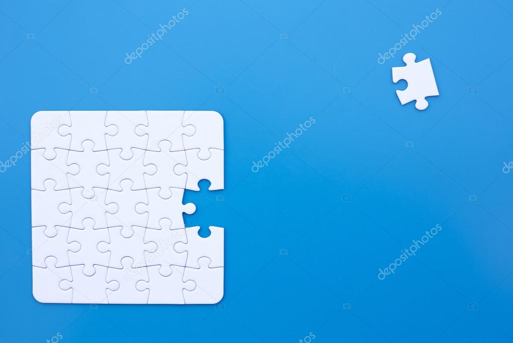 white puzzle on blue table