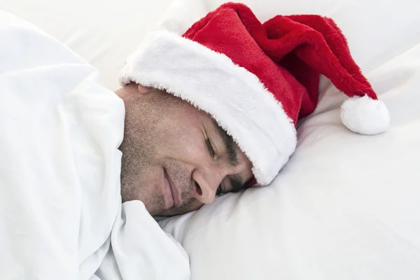 Hombre durmiendo con sombrero de santa — Foto de Stock